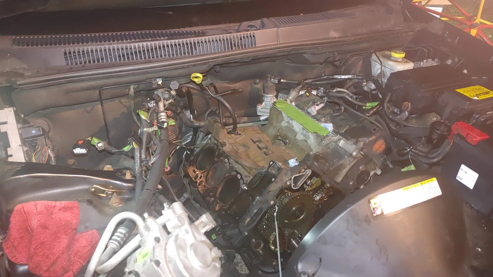 Engine disassembly and cylinder head removal in progress