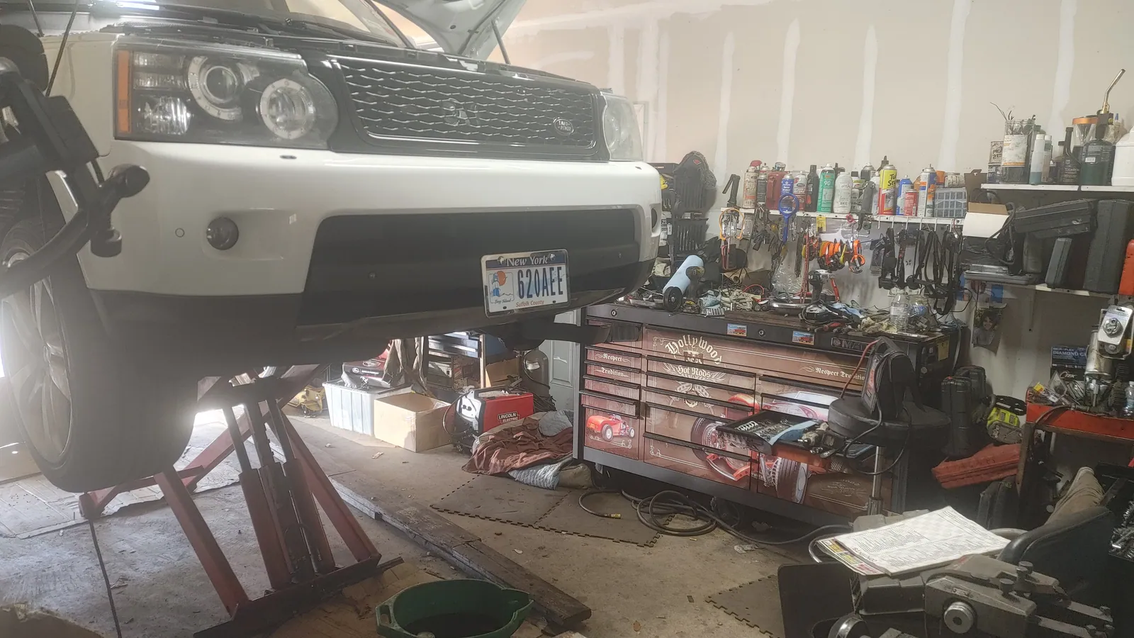 Land Rover SUV elevated on scissor lift for service